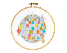 a cross - stitch pattern with an image of a fish in the center, on a white background