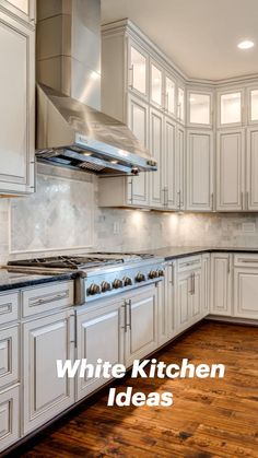 an empty kitchen with white cabinets and wood flooring is pictured in this image from the front view