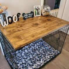 a wooden table with metal cage on top