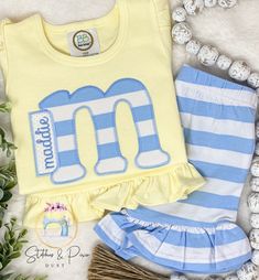 Girls Monogram Shirt Outfit/Personalized yellow/blue Summer Set/Monogram/Stripe Ruffle Short Outfit/Toddler Monogram Shirt/Spring Shirt Select Shirt Size Select Short Size or no shorts To Order: ~Select Size and shirt or bubble ~Leave Monogram  to be added to the personalization box.   *Wash inside out on cold gentle cycle and hang to dry. Do not use bleach. Iron inside out on low heat without steam.   *CURRENT PRODUCTION TIME: Orders ship a FULL 2 WEEKS from purchase date. If your ship date falls on a weekend or holiday, your order will ship the following business day.   *Free Shipping is offered in my shop, I will ship your items First Class Mail.  If you need the item sooner you can purchase priority shipping paying the difference.  https://www.etsy.com/StitchesandPixiDust/listing/83837 Blue Cotton T-shirt With Ruffles, Striped Cotton Top For Playwear, Blue Cotton Ruffle Sets, Blue Cotton Ruffled Sets, Striped Tops For Playwear In Spring, Striped Tops For Spring Playwear, Cute Striped Cotton Sets, Ruffle Shorts Outfit, Monogram Shirt