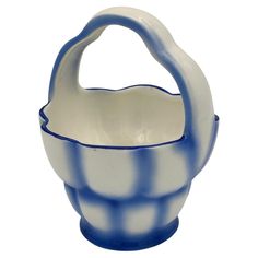 a blue and white ceramic basket with handle