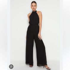 From Vince Camuto, This Jumpsuit Features: Color Black Wide Leg Silhouette Halter Neckline Sleeveless Smocked Waistline Lined Back Tie And Zip Closure Approx. 26" Inseam Polvester Machine Wash/Dry Flat About Vince Camuto Vince Camuto Is A Global Lifestyle Brand Recognized For Quality Materials And On-Trend Designs. Their Modern Collections Feature Distinctive Designs, Exceptional Materials, Expert Craftsmanship And Unparalleled Value. Known For Its Well-Crafted And Fashion-Forward Aesthetic, Vince Camuto Collections Fuse Designer Wear And Fast-Fashion For Accessible Luxury. Summer Workwear Halter Neck Jumpsuits And Rompers, Summer Workwear Halter Neck Jumpsuit, Black Strapless Halter Neck Jumpsuit For Night Out, Black Sleeveless Jumpsuits And Rompers For Date Night, Black Sleeveless Jumpsuits For Date Night, Black Strapless Jumpsuit For Summer Evenings, Black Strapless Jumpsuit For Date Night, Black Summer Evening Jumpsuits And Rompers, Black Jumpsuits And Rompers For Summer Evenings