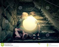 two people sitting on the steps with a glowing ball in their hands, looking at each other