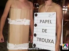 two men in paper costumes holding a sign that says papel de trouxa