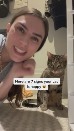 a woman laying on the floor next to a cat and texting her name here are 7 signs your cat is happy