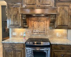 a stove top oven sitting inside of a kitchen next to wooden cabinets and counter tops