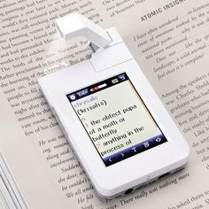 an electronic device with a bookmark attached to it sitting on top of a table