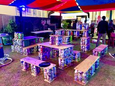 several tables and benches made out of soda cans