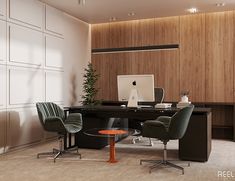 an office desk with two chairs and a computer on it in front of a wooden paneled wall