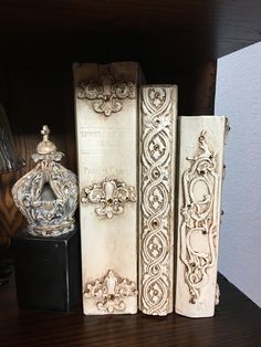 an assortment of decorative books on a shelf