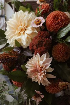 a vase filled with lots of different colored flowers