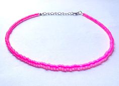 This beautiful neon pink matte beaded necklace is handmade with pink matte beads. It comes in 4 sizes (14, 16, 18, 20 inches) ranging from more of a choker fit to a longer necklace. Every necklace also comes with additional extender chain, making it easily adjustable.  The necklace makes a great gift for graduation, a birthday, or another special occasion. It is an awesome summer necklace as the color really catches the light. Summer Pink Choker As Gift, Pink Round Beads Choker For Festival, Pink Choker With Round Tiny Beads, Pink Tiny Beads Choker Necklace, Festival Pink Round Beads Choker, Pink Beaded Choker For Festivals, Pink Beaded Festival Choker Necklace, Handmade Pink Choker With Round Beads, Pink Handmade Choker With Round Beads