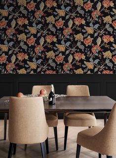 a dining room table with chairs and a bottle of wine on it in front of a floral wallpaper