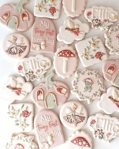 some cookies that are decorated with different designs and words on them, all in pastel colors