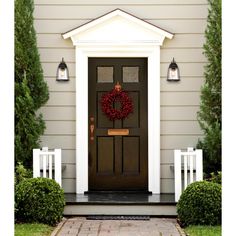 a front door with a wreath on it