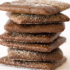 a stack of cookies with powdered sugar on top