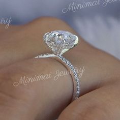 a woman's hand with a diamond engagement ring on her left side, and the words marriage jewelry written in cursive writing