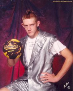 a man in silver suit holding a yellow ball