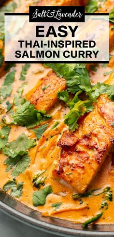 salmon curry in a skillet with cilantro and parsley on the side