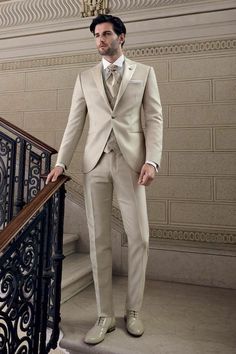 a man in a tuxedo is standing on the stairs