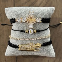 This set of 4 adjustable bracelets is a must-have for anyone who loves to accessorize. The set includes a San Judas bracelet, a Virgen cross bracelet, a tennis adjustable bracelet, and an initial bracelet. All of the bracelets are adjustable, making them suitable for wrists ranging from 6.5" to 11". The San Judas bracelet is a symbol of faith and protection, making it a great addition to any outfit. The Virgen cross bracelet is a beautiful piece of jewelry that can be worn on any occasion. The s Keychain Necklace, Set Bracelet, Initial Bracelet, Cross Bracelet, Anklet Bracelet, Gold Plated Bracelets, Evil Eye Necklace, Evil Eye Bracelet, Evil Eye Jewelry