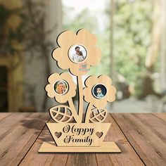 a family wooden table top with four pictures on it and the words happy family written below