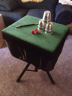 a green table with two cups on it