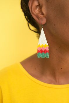 a close up of a person wearing some kind of earring with beads on it