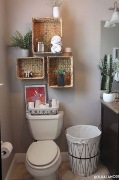 a white toilet sitting inside of a bathroom next to a wooden shelf filled with baskets