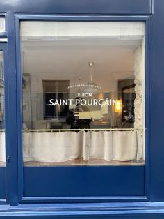 the front window of a store that sells clothing and other items in paris, france