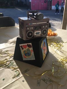 an old fashioned radio sitting on top of a table next to other items and confetti