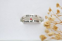 Personalized Class Ring Set, Sterling Silver, Affordable Class Rings, High School Rings, Class of 2023, 2024, 2025, 2026, 2027 A stylish alternative to traditional class rings, we're excited to offer a modern stackable version that is fun to wear! Please read all details below. Your set will include 4 rings: 1. Name Ring 2. Birthstone Ring OR School Color 3. Beaded Spacer Ring 4. Class of Ring S I Z I N G If unsure of size, please have a jeweler size your finger. I am unable to resize your ring. High School Rings, College Ring, Class Rings High School, School Rings, College Rings, Class Rings, Ring Spacer, Graduation Year, Birthstone Colors