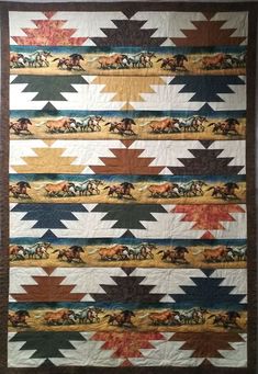 a quilt that has horses on it