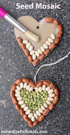 two clay hearts shaped like peanuts and seed mosaics