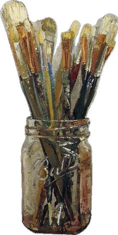 a jar filled with lots of paint brushes