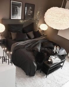 a black and white bedroom with candles on the bed