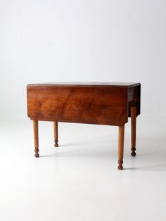 an old wooden bench sitting on top of a white floor