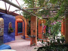 an outdoor area with colorful walls and potted plants