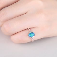 You are looking at a vintage Lab-created blue opal and diamond engagement ring.A perfect anniversary gift, birthday gift,wedding engagement ring. Ring Information Main Stone *Lab-created blue opal *6x8mm oval cut *Weight:it's approx 1.5 ct. *Setting: 4-prongs Side Stone *0.18 carat natural diamond Metal * Solid 10k 14k &18k. *Color:white gold,yellow gold,rose gold. Custom Order *The main stone can be other gemstones you can imagine,any birthstone can be made.Please contact me if you need thi Oval Opal Promise Ring, Oval Opal Promise Ring With Accent Stones, Blue Opal Round Ring, Blue Round Opal Ring, Oval Opal Ring With Accent Stones, Blue Oval Opal Ring Fine Jewelry, Blue Oval Opal Ring Gift, Oval Opal Promise Ring With Birthstone, Oval Opal Birthstone Ring For Promise