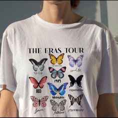 a woman wearing a white t - shirt with butterflies on it