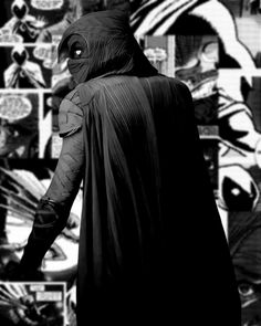 a man in a batman costume walking down the street with his hand on his hip