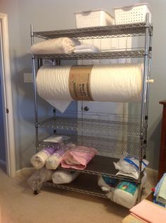 a metal shelf with two rolls of toilet paper on it