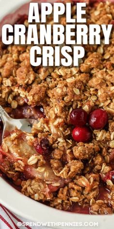 an apple cranberry crisp in a bowl with a spoon