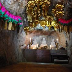 an altar with candles and decorations in a cave