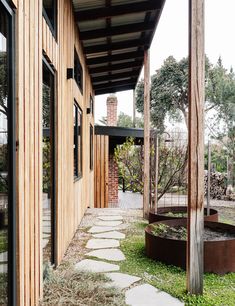 an outdoor area with stone walkways and wooden walls