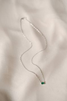 The Ezra Pavé Chain Necklace showcases one gleaming stone on a graceful chain, a brilliant accent for your daily necklace stack. Part of our Stackable Jewelry assortment. Chain necklace with one claw-set emerald cut simulated stone. Gold: 18K gold plated brass. Silver: rhodium plated brass. Nickel- and lead-free. 16" long with 2" extender. Avoid water, soap, and harsh chemicals. Store in a box or bag in a cool, dry place. Clean using a dry soft cloth. Elegant Emerald Necklace With Cable Chain As Gift, Elegant Green Birthstone Necklace With Delicate Chain, Emerald Jewelry With Delicate Chain As Gift, Emerald Jewelry With Delicate Chain For Gift, Emerald Necklace With Delicate Chain As Gift, Emerald Necklace With Delicate Chain For Gift, Elegant Emerald Necklace With Cable Chain, Dainty Emerald Pendant Necklace With Delicate Chain, Formal Green Necklace With Delicate Chain