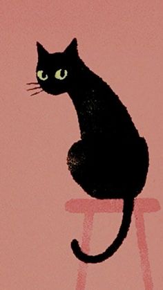 a black cat sitting on top of a stool with its eyes wide open and green eyes