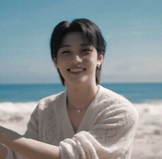 a woman holding a cell phone on the beach