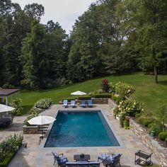 an outdoor swimming pool surrounded by lawn furniture