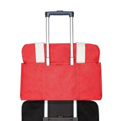 two pieces of luggage are stacked on top of each other, one red and the other black